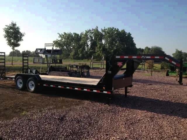 24ft Gooseneck flatbed trailer with toolbox and stand up ramps